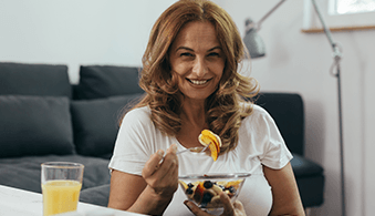 Woman eating fruit salad