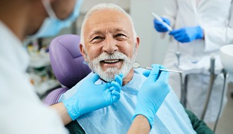 Man smiling at dentist during checkup