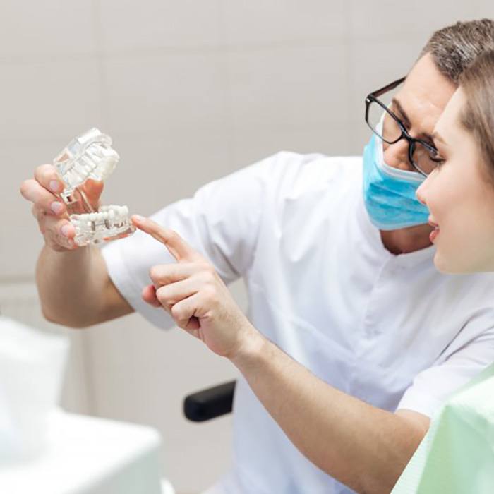 a dentist explaining dental implants to a patient